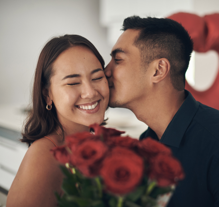 En la imagen se muestra una pareja feliz con flores